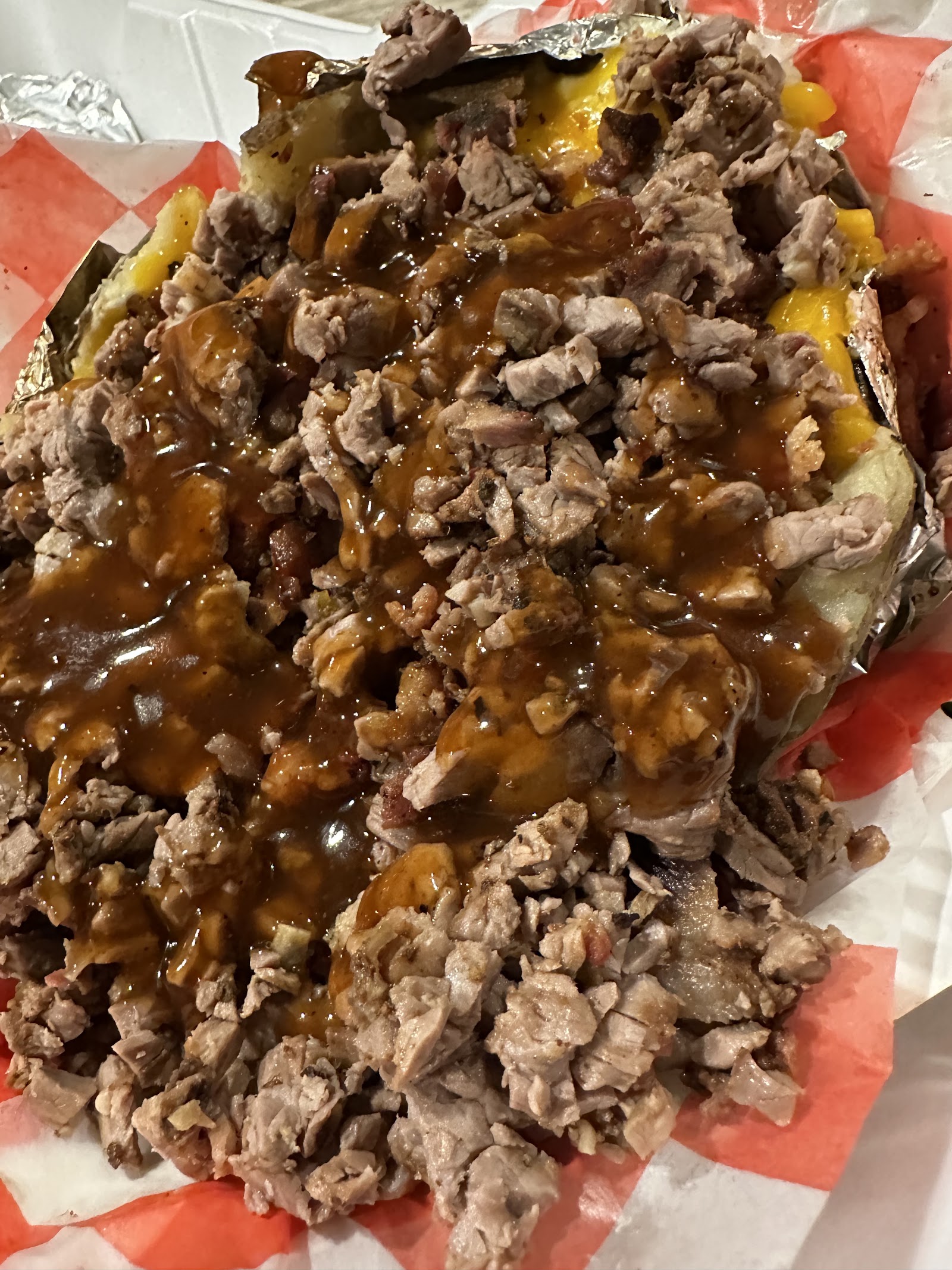 Loaded baked potato piled with chopped brisket and gravy